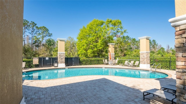 pool featuring a patio and fence