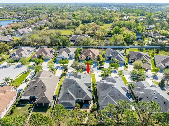 bird's eye view with a residential view and a water view