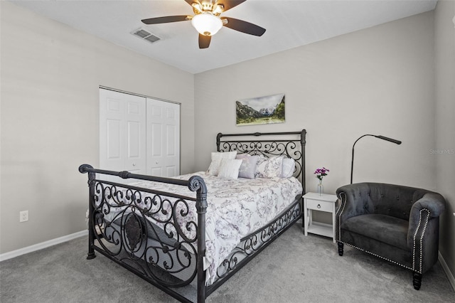 carpeted bedroom with visible vents, baseboards, a closet, and a ceiling fan