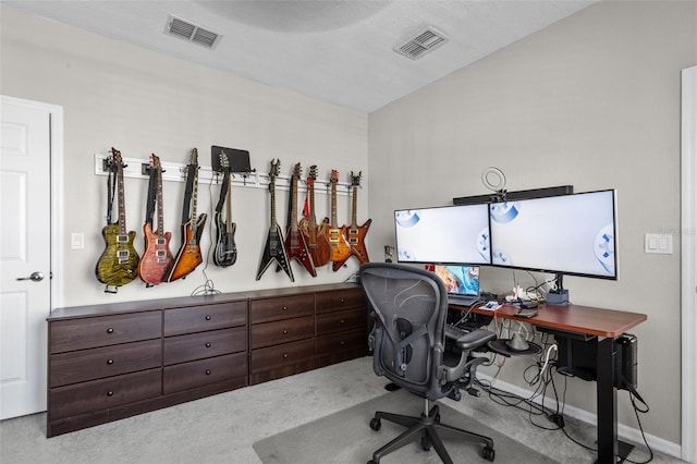 carpeted office featuring visible vents and baseboards