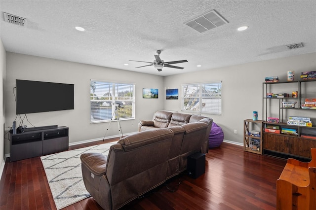 living area featuring visible vents, plenty of natural light, and wood finished floors