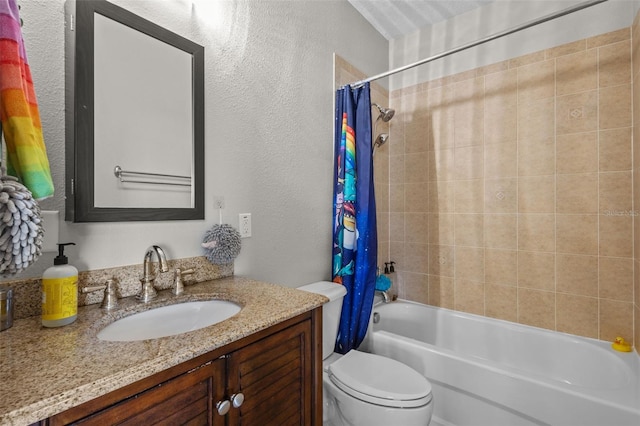 bathroom with vanity, shower / bath combination with curtain, toilet, and a textured wall