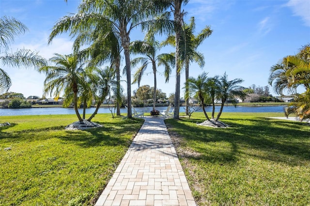 view of home's community featuring a water view and a lawn