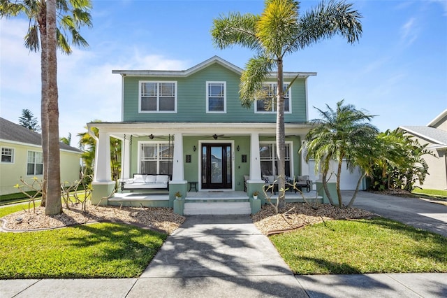 view of front facade featuring a porch, driveway, and a garage