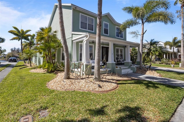 view of front of home with a porch and a front lawn