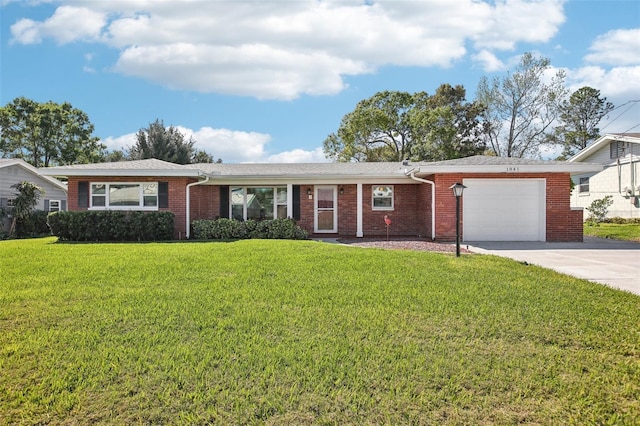 single story home with a front yard, brick siding, an attached garage, and driveway