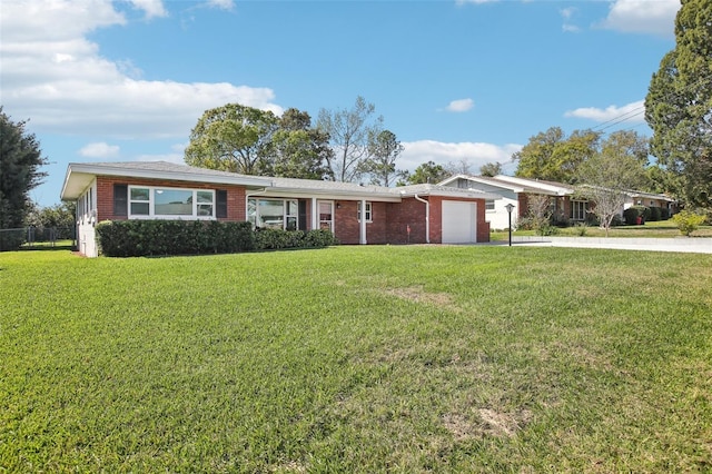 single story home with brick siding, a front lawn, concrete driveway, and an attached garage