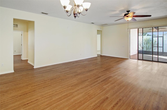 spare room with light wood-type flooring, visible vents, and baseboards