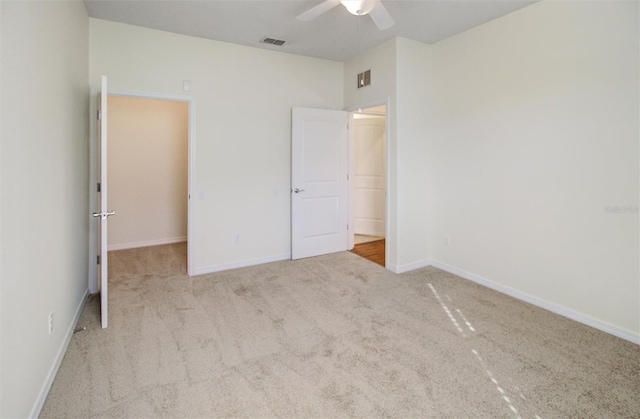 unfurnished bedroom with carpet flooring, baseboards, visible vents, and ceiling fan