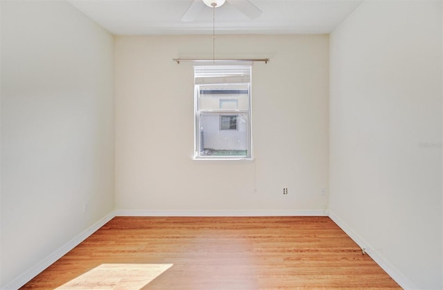 unfurnished room with light wood-style flooring, a ceiling fan, and baseboards