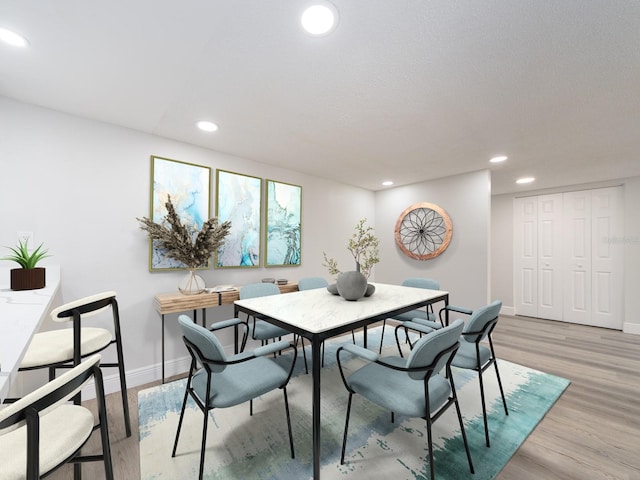 dining room featuring recessed lighting, baseboards, and light wood-style flooring