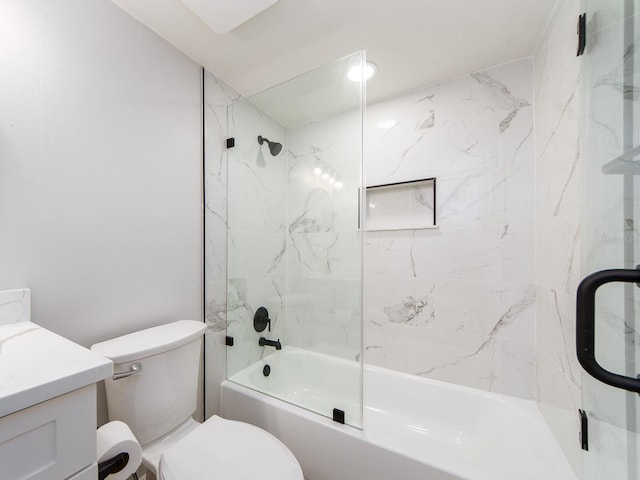 bathroom with vanity, toilet, and shower / bath combination with glass door