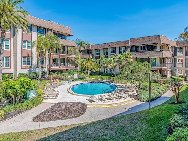 view of pool with a yard