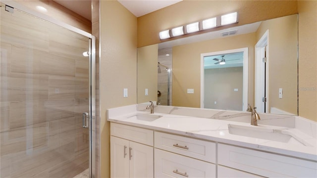 bathroom featuring a shower stall, double vanity, visible vents, and a sink