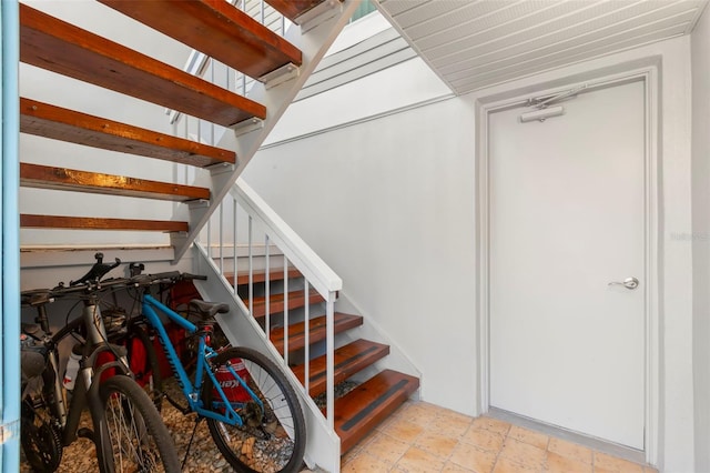 staircase featuring stone finish flooring