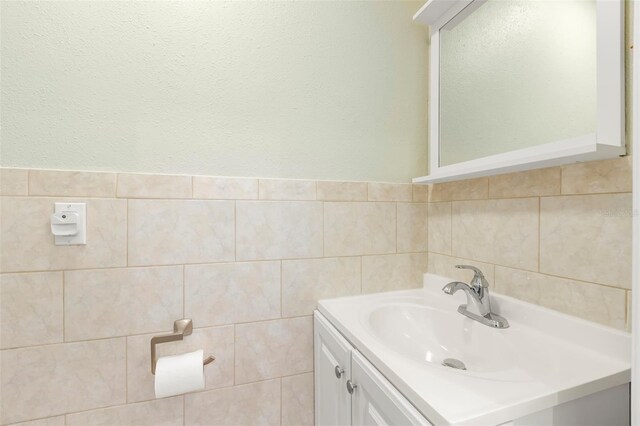 bathroom with tile walls and vanity