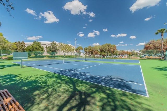 view of tennis court with fence