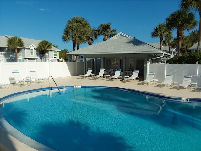 community pool featuring a patio and fence