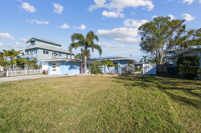 exterior space featuring concrete driveway and fence