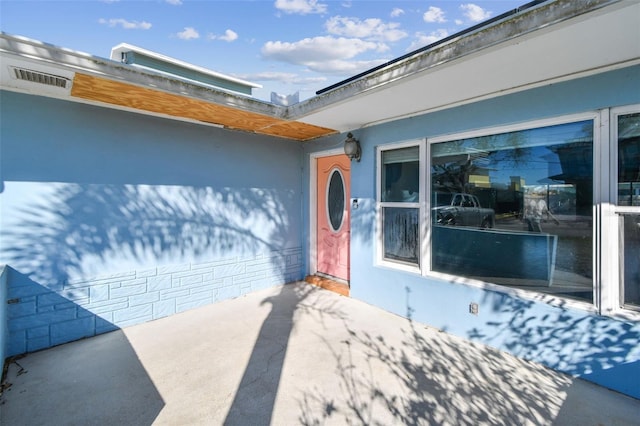 2451 Baywood Dr W, Dunedin, FL 34698 - doorway to property featuring a garage and driveway