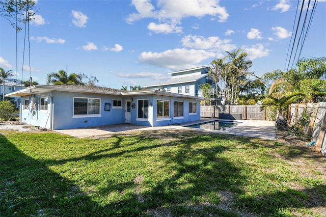 2451 Baywood Dr W, Dunedin, FL 34698 - rear view of house with a patio area, a lawn, a fenced backyard, and stucco siding