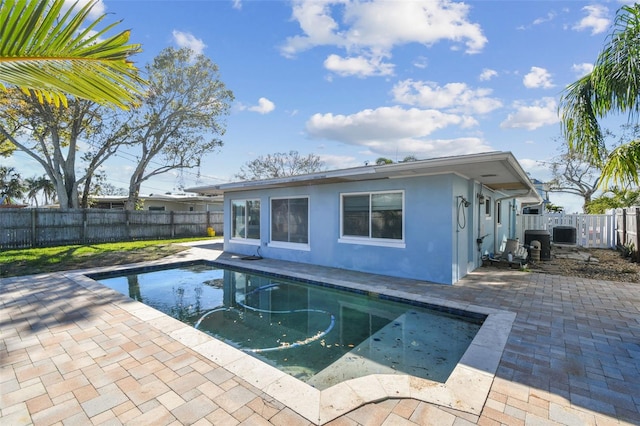 2451 Baywood Dr W, Dunedin, FL 34698 - view of swimming pool featuring a fenced in pool, a patio, central AC, and a fenced backyard