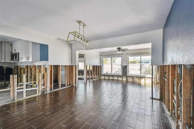 2451 Baywood Dr W, Dunedin, FL 34698 - unfurnished living room with a ceiling fan and wood tiled floor