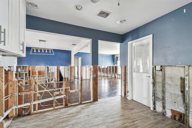 2451 Baywood Dr W, Dunedin, FL 34698 - corridor featuring visible vents and wood finished floors