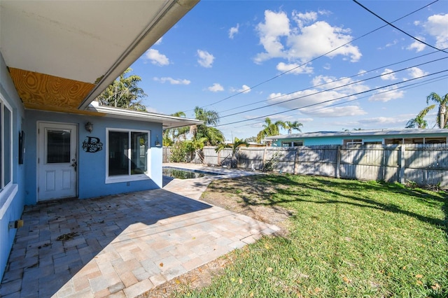 2451 Baywood Dr W, Dunedin, FL 34698 - view of yard featuring a fenced backyard and a patio area