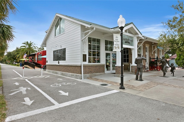 2451 Baywood Dr W, Dunedin, FL 34698 - exterior space featuring french doors and brick siding