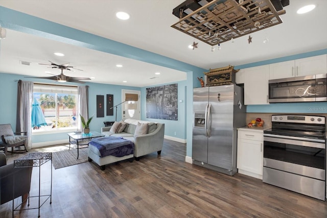 kitchen featuring stainless steel appliances, open floor plan, white cabinets, and dark wood finished floors