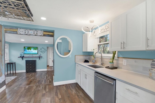 kitchen with white cabinetry, dark wood finished floors, a sink, light countertops, and dishwasher