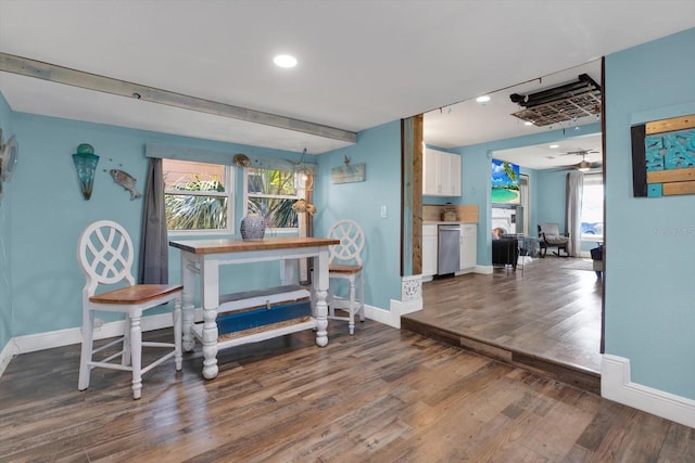 dining room featuring wood finished floors, baseboards, and a healthy amount of sunlight