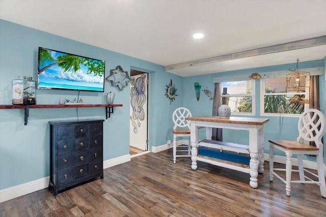 interior space with baseboards and wood finished floors