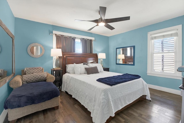 bedroom with dark wood-style floors, a ceiling fan, and baseboards