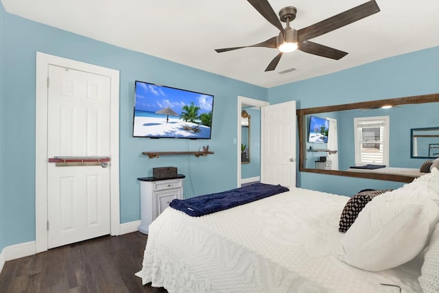 bedroom with dark wood finished floors, a ceiling fan, visible vents, and baseboards