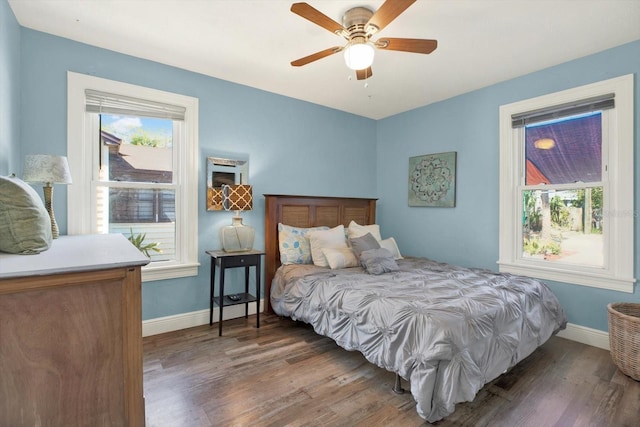 bedroom featuring a ceiling fan, baseboards, and wood finished floors