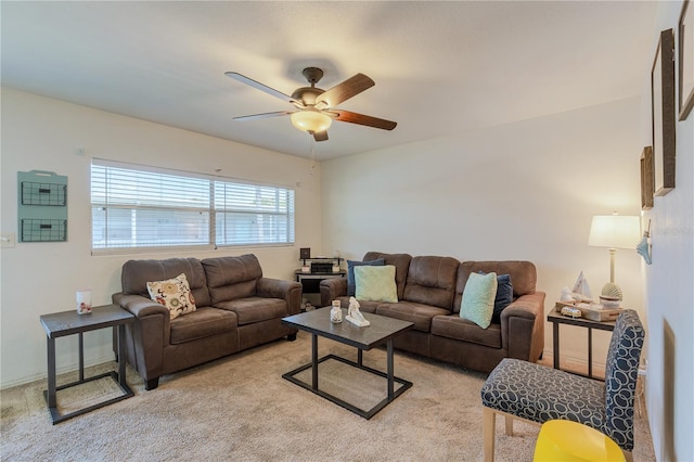 living area featuring light colored carpet and ceiling fan