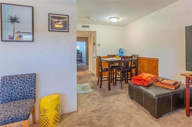 carpeted dining area with visible vents