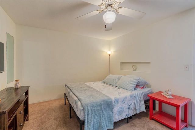 bedroom with a ceiling fan and light colored carpet