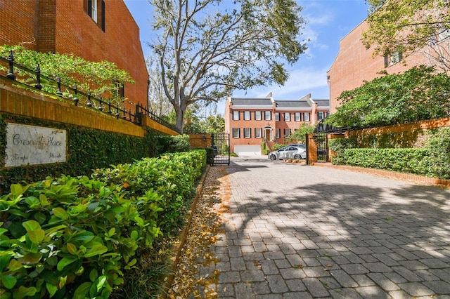 view of property's community with fence and a gate