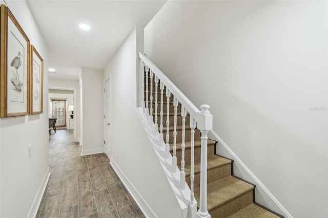 stairs with recessed lighting, baseboards, and wood finished floors