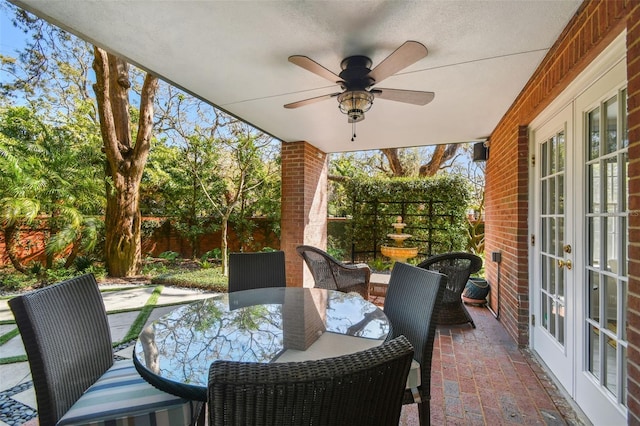 view of patio / terrace featuring a ceiling fan, outdoor dining area, french doors, and a fenced backyard