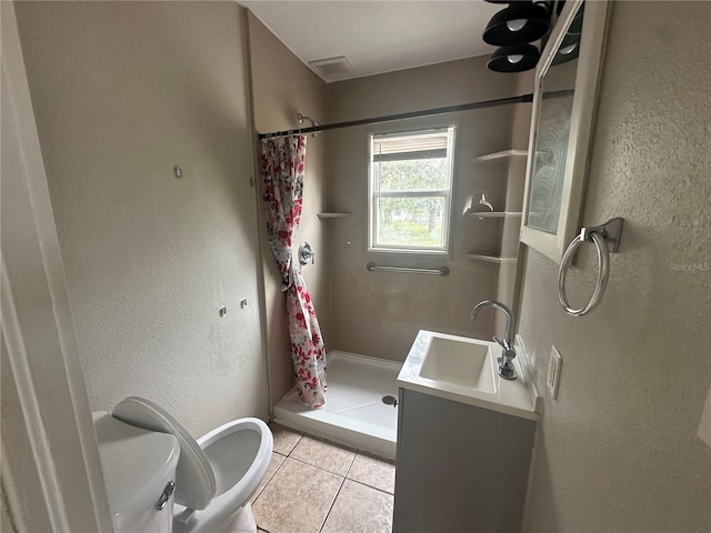 bathroom featuring vanity, a shower stall, toilet, and tile patterned floors