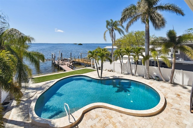 pool featuring a patio, fence, a boat dock, and a water view