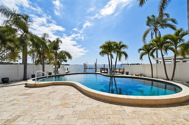 pool featuring a boat dock, a fenced backyard, and a patio area