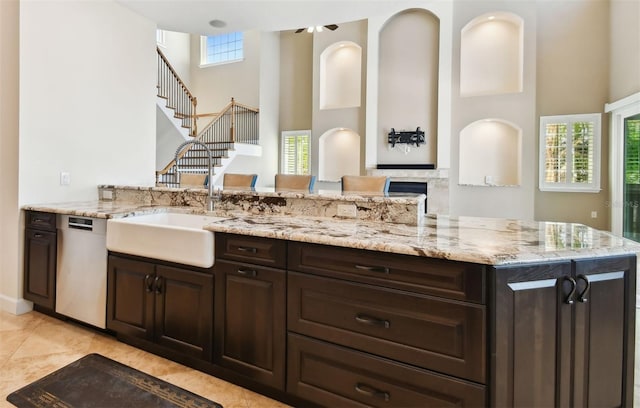 bathroom with tile patterned flooring, plenty of natural light, a fireplace, and a towering ceiling