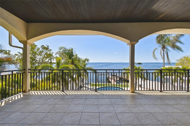view of patio / terrace with a water view and a balcony