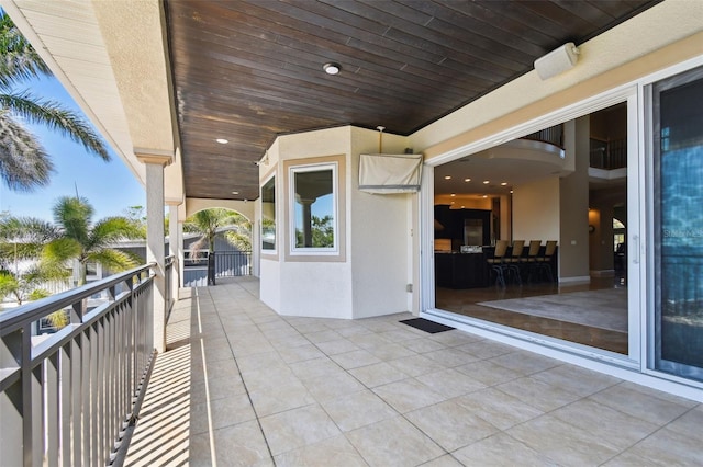 view of patio featuring a balcony