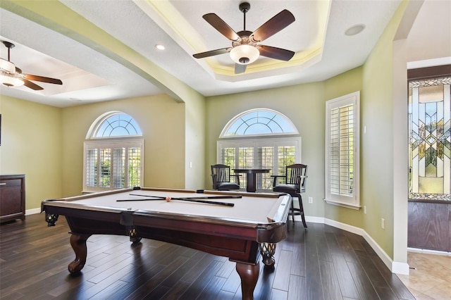 playroom with ceiling fan, a raised ceiling, and wood finished floors
